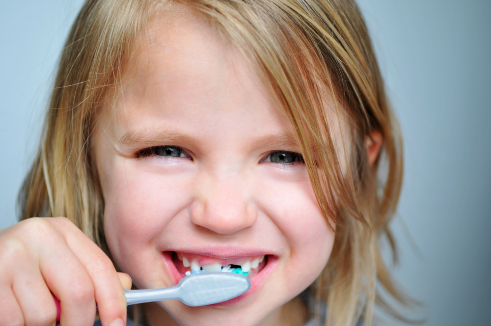 Young Girl Brushing Her Teeth